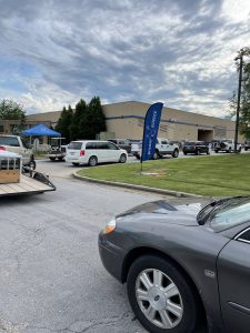 Car line outside Brewer Science HQ of community recycling appliances