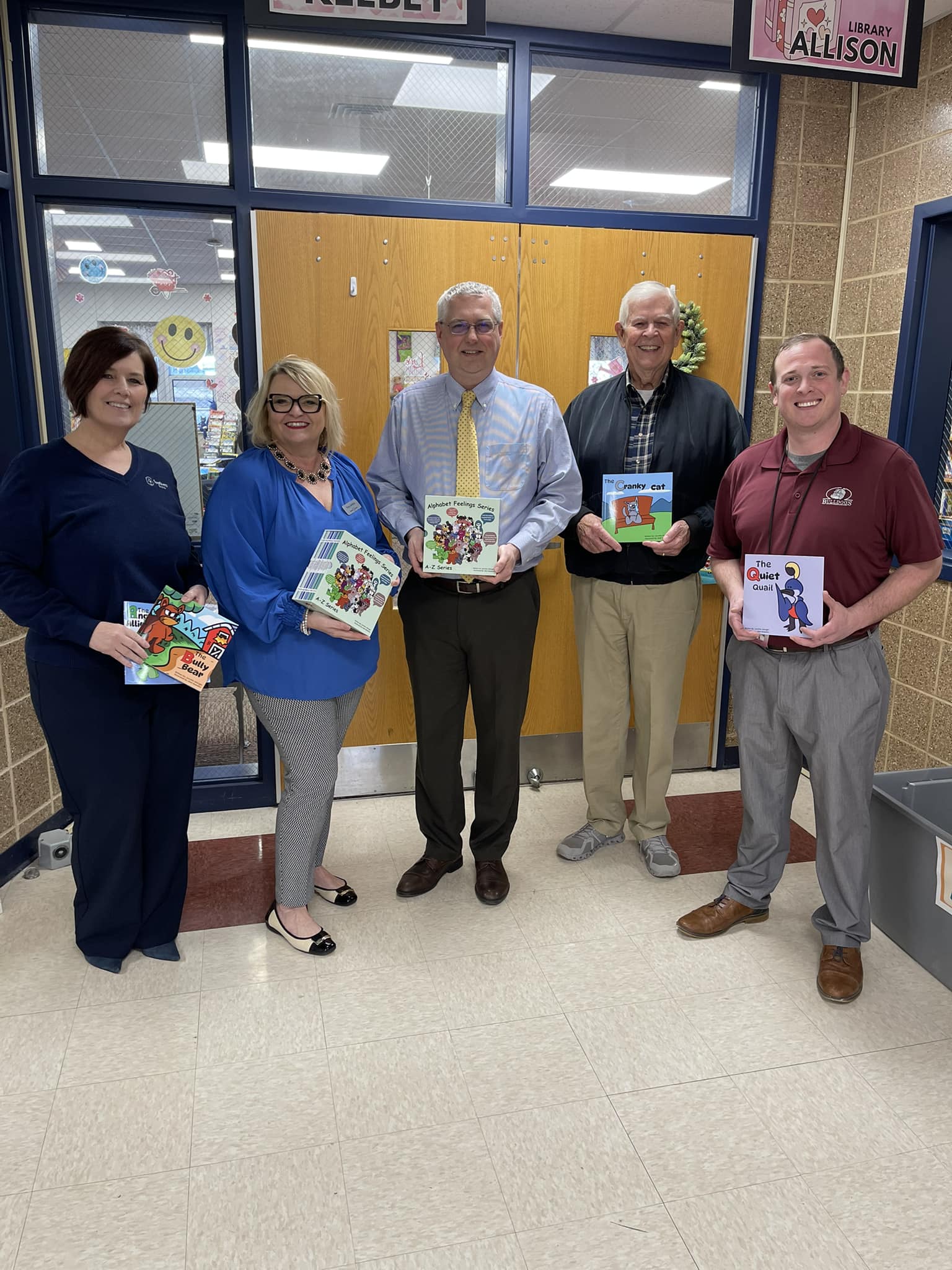 Tracy Jenkins, Corporate Relations Representative at Brewer Science, provides donated sets of The Alphabet Feelings Series to Rolla Public Schools administrators.