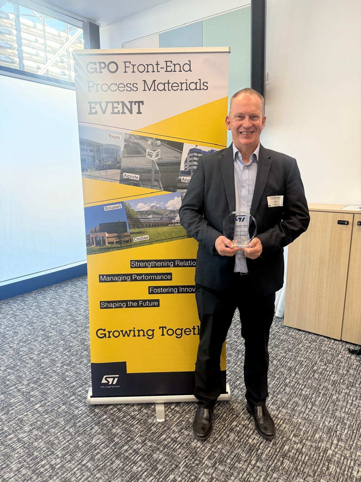 Caption: Richard Boittier, Senior Account Manager, Brewer Science, holding the 2026 Supplier Award from ST.